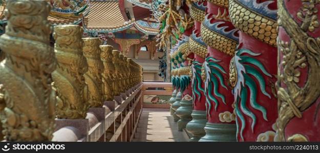 Chonburi, Thailand - 05 Feb 2022 : Panoramic of Sculptured dragons pillars and corridor in Chinese-style temple. Wihan Thep Sathit Phra Ki Ti Chaloem, Selective focus.