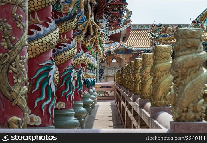 Chonburi, Thailand - 05 Feb 2022 : Sculptured dragons pillars and corridor in Chinese-style temple. Wihan Thep Sathit Phra Ki Ti Chaloem, Selective focus.