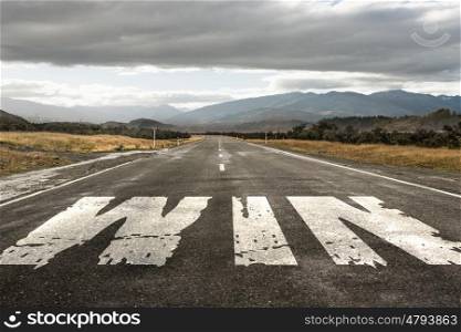 Choose right direction. Natural landscape of asphalt road and drawn win word