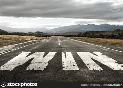 Choose right direction. Natural landscape of asphalt road and drawn win word