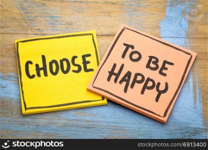 Choose to be happy advice - inspirational handwriting on sticky notes against grunge wood