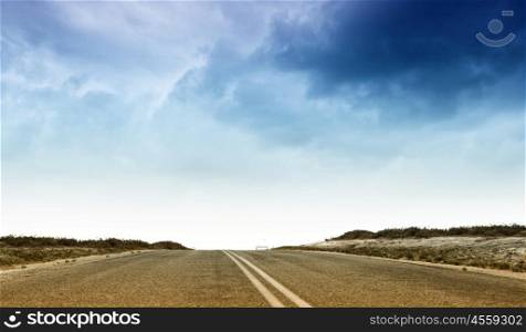 Choose your way. Empty suburban asphalt road with blue sky