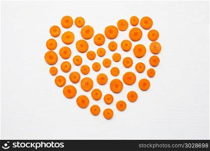 Chopped carrot slices heart shape isolated .. Chopped carrot slices heart shape isolated on white background.