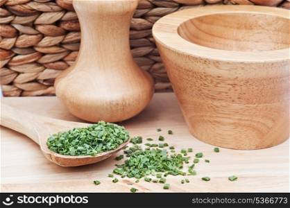 Chopped chives in rustic kitchen scene with wooden utensils