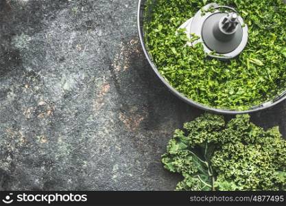 Chopped kale leaves for salad making, cooking on rustic background , top view, place for text. Vegan or vegetarian nutrition, diet, detox and healthy food concept