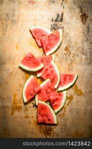 Chopped pieces of watermelon . On wooden background.. Chopped pieces of watermelon .