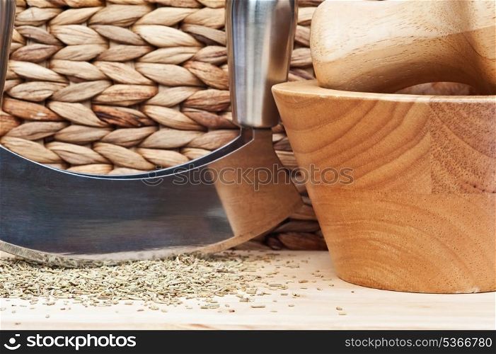 Chopped rosemary with herb chopper in rustic kitchen setting