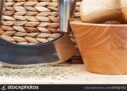 Chopped rosemary with herb chopper in rustic kitchen setting