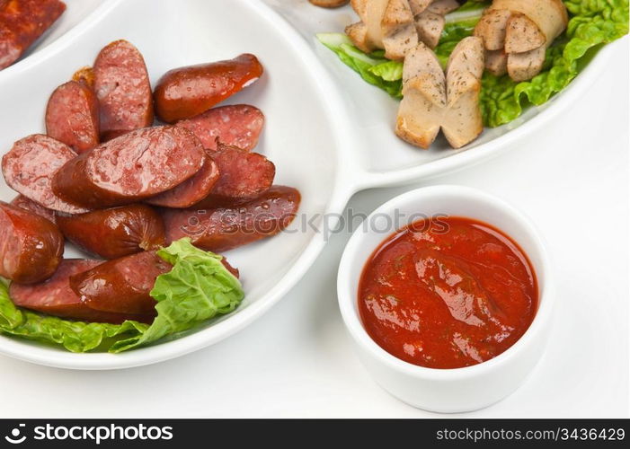 chopped sausages fried with vegetables and spices isolated on white background