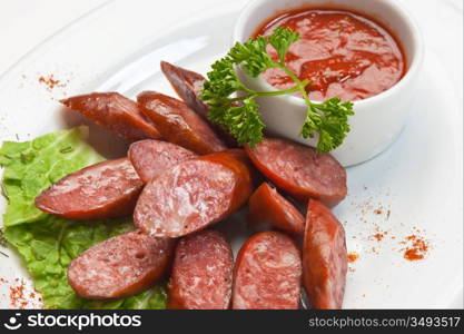 chopped sausages fried with vegetables and spices isolated on white background