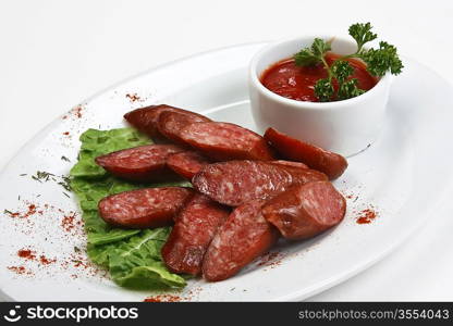 chopped sausages fried with vegetables and spices isolated on white background