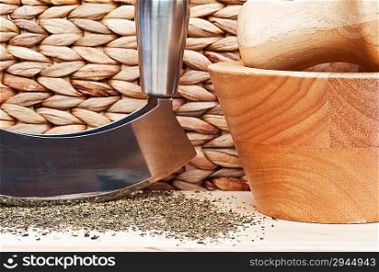 Chopped tarragon in rustic kitchen scene with herb chopper and wooden utensils