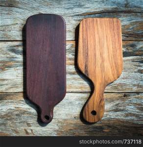 Chopping board on wooden plank background