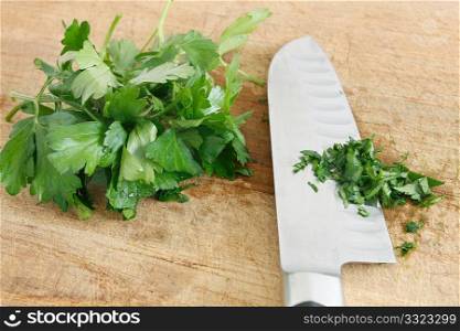 Chopping parsley on a wooden surface