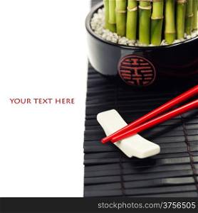 Chopsticks and a lucky bamboo plant - oriental style table serving concept