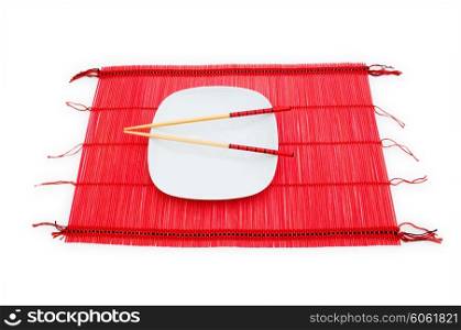 Chopsticks and plate on the bamboo mat