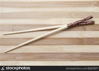 chopsticks isolated on wood background