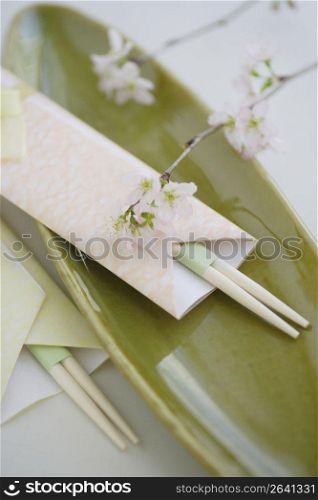Chopsticks on a green plate