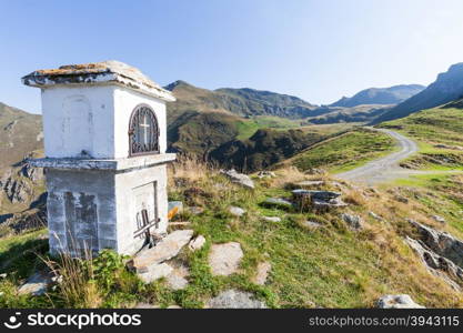 Christian chapel during a sunny day on Italian Alps - faith concept