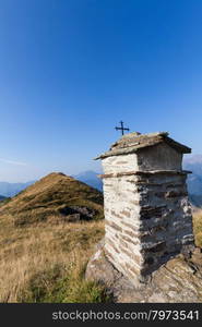 Christian chapel during a sunny day on Italian Alps - faith concept