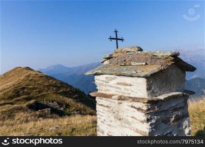 Christian chapel during a sunny day on Italian Alps - faith concept