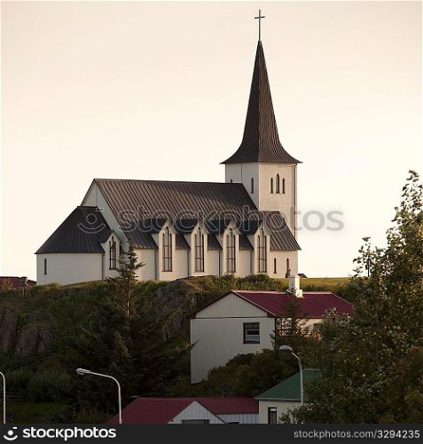 Christian church on hilltop overlooking dwellings
