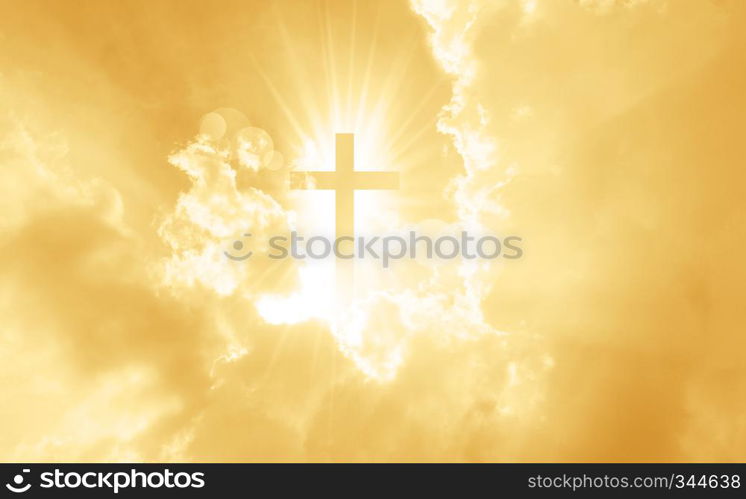 Christian cross appears bright in the yellow sky background