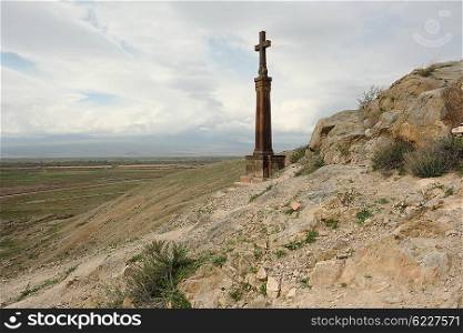 Christian cross near ancient monastery Khor Virap in the mountains of Armenia. Was founded in years 642-1662.