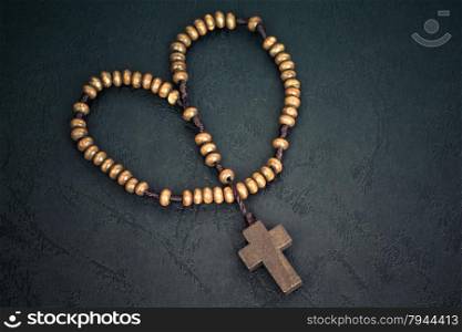 Christian cross necklace on Holy Bible book, Jesus religion concept as good friday or easter festival in heart shape