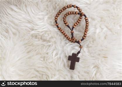 Christian cross necklace on sheep wool, Jesus religion concept as good friday or easter festival