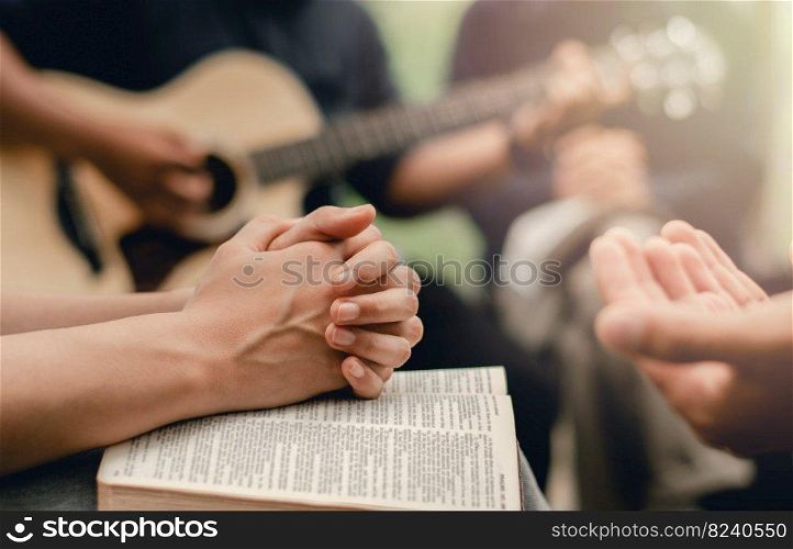 Christian prayer group with bible by playing the guitar to worship God