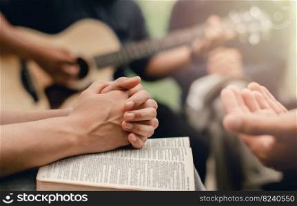 Christian prayer group with bible by playing the guitar to worship God
