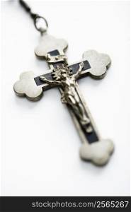 Christian rosary crucifix on white background.
