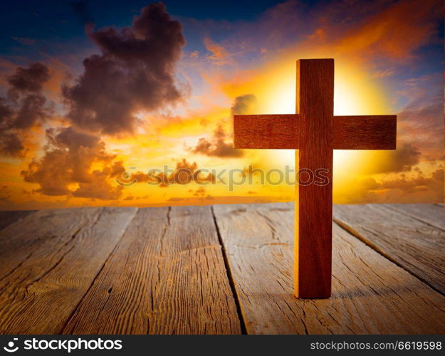 Christian wood cross on sunset sky wooden made