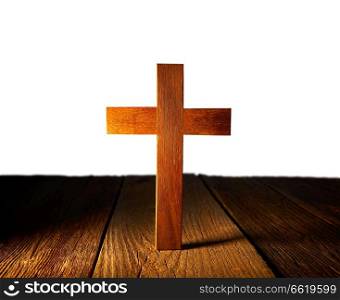 Christian wood cross on white and wooden background