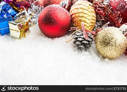 christmas accesories, gift boxes and spheres on snow