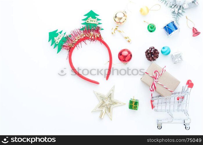 Christmas accessories and shopping cart with gift boxes on white background