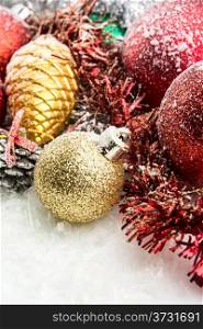 christmas accessories and spheres on snowy background
