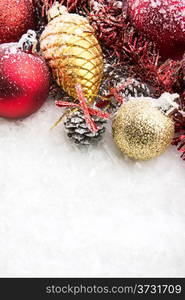 christmas accessories and spheres on snowy background