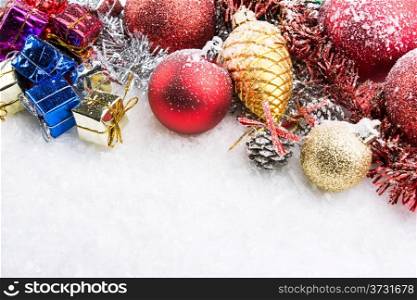 christmas accessories, gift boxes and spheres on snow