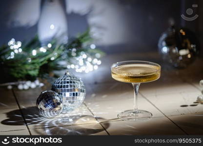 Christmas and New Year celebration with champagne. New Year holiday decorated table. Festive New Year champagne and silver baubles. Close up. Christmas greeting card with copy space.. Festive New Year champagne