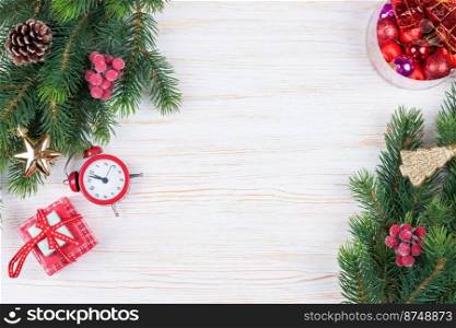 Christmas and new year composition. Christmas decorations, fir tree branch, garland, clock, gift on white wooden background. Flat lay, top view, copy space.. Cristmas and New Year background. top view, flat lay.