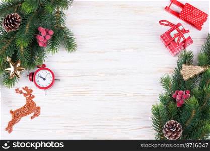 Christmas and new year composition. Christmas decorations, fir tree branch, garland, red santa claus hat, clock, gift on white wooden background. Flat lay, top view, copy space.. Cristmas and New Year background. top view, flat lay.