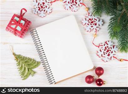Christmas and new year composition. Christmas decorations, garland, clock, gift and blank notebook on white wooden background. Flat lay, top view, copy space.. Cristmas and New Year background. top view, flat lay.