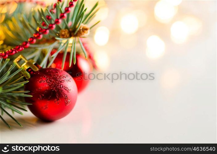 christmas and new year fir-tree. christmas and new year fir-tree with red glass balls and festive garland lights blurred background