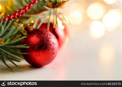 christmas and new year fir-tree. christmas and new year fir-tree with red glass balls and festive garland lights blurred background