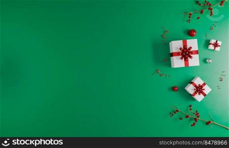 Christmas and New Year holiday green background mockup. New Year decoration flat lay. Christmas greeting card. White and red present boxes and christmas ornaments. Christmas celebration concept.