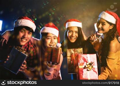 Christmas and New Year party celebration by Asian teen. Holiday and Happiness concept. Friendship and Relax theme. Yellow gold tone.