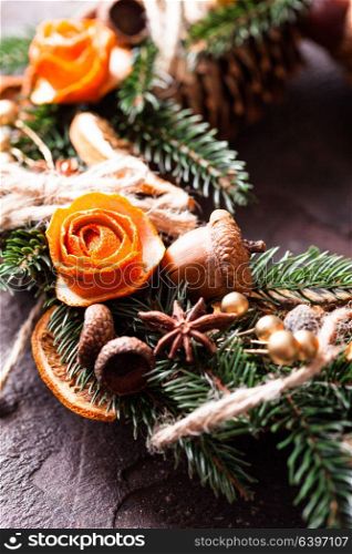 Christmas aromatic eco wreath. Christmas aromatic eco wreath with dry orange and anise stars, decorated tangerine peel roses, closeup details