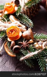 Christmas aromatic eco wreath. Christmas aromatic eco wreath with dry orange and anise stars, decorated tangerine peel roses, closeup details